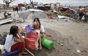 A survivor holds a statue of Jesus Christ, her only saved belonging, after a super Typhoon Haiyan battered Tacloban city, central Philippines