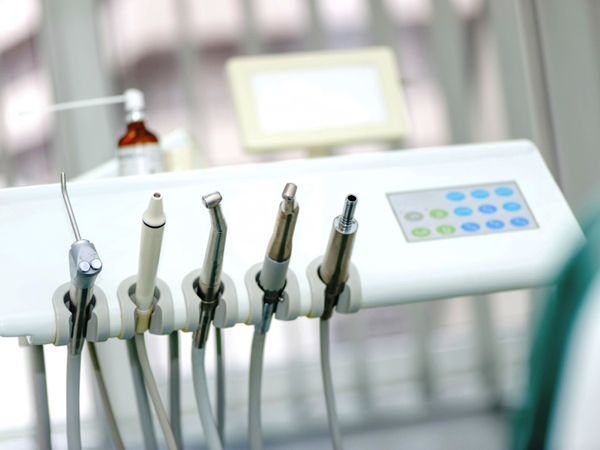 Dental tools on a dentist's chair with white background