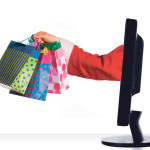 santa clause sticking hand out of monitor with gifts